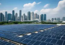 Equinix Expands Singapore Clean Energy with 50 MWp Solar PPA Rows of blue solar panels on a rooftop with a city skyline in the distance under a blue sky.