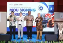 INDO FIREX 2026 EXPO & FORUM: “Entering a New Identity as Indo Firex, Rescue & Disaster Expo & Forum” Four professionals on a blue-carpet stage posing with circular hand gestures in front of a banner that reads 'MOU SIGNING' ceremony behind them.