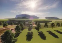 ABB, Rolls-Royce SMR Sign Agreement on SMR Collaboration Wide view of a futuristic building with a curved glass roof, surrounded by lawns, trees, and a bright sunlit sky.