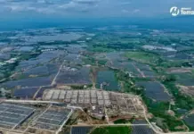 MTerra Solar Phase 1 Begins Commercial Operations Aerial view of a vast solar farm with rows of panels across green countryside; Terra Solar logo in the corner of the image.